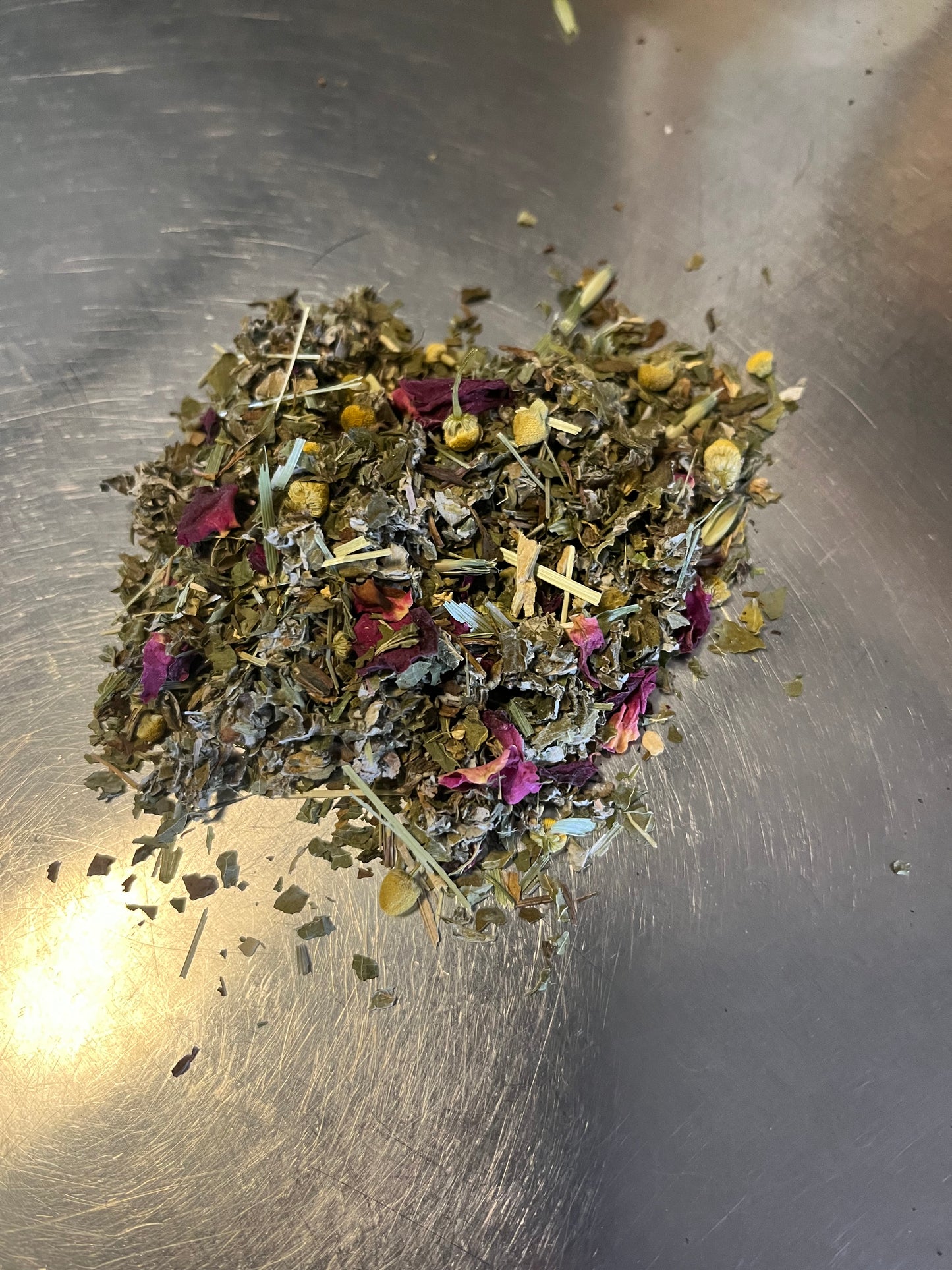 Herbal tea leaves on a metallic surface